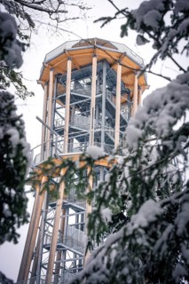 A high observation tower in the forest is surrounded by snow-covered trees, Himmelsglück