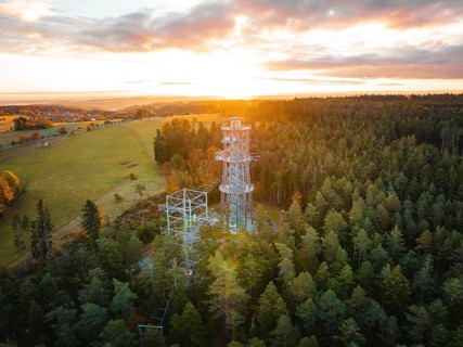 A tower towers over the thick forests at dusk, Himmelsglück observation tower with Flying Fox,