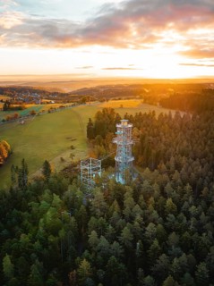 Tower surrounded by forests and meadows at sunset, Himmelsglück observation tower with Flying Fox,