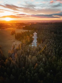 Landscape view with observation tower in foreground and sunset, Himmelsglück observation tower with