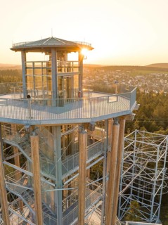 Observation tower with a view of a city in the background at sunset, Himmelsglück observation tower