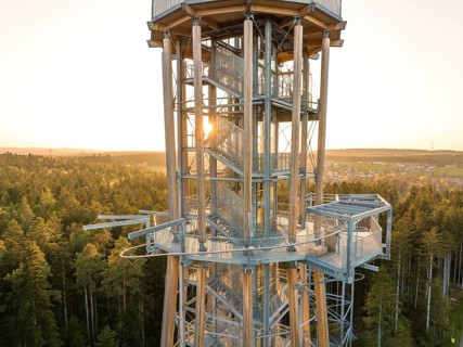 Metal observation tower at sunset surrounded by thick forests, Himmelsglück observation tower with