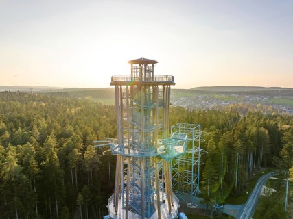 High observation tower in a wooded area at sunset with a view over the valley, Himmelsglück