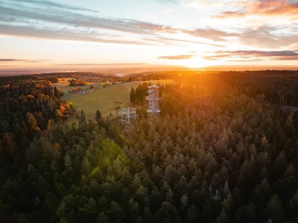 Sunset behind an observation tower in the middle of a vast forest, Himmelsglück observation tower