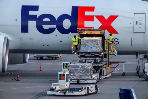 FedEx Express Boeing 777-FS2 cargo plane is unloaded, air freight container, air freight center at