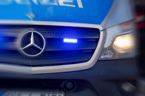 Symbolic image police operation: close-up of a blue light on a police car (digitally reworked)