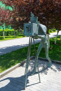 Bronze statue of a photographer with an antique camera in a park, statue in Borjomi Park, Borjomi