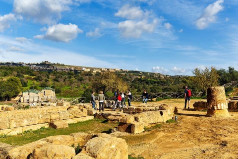 Tourist group, archaeological site in the Valley of the Temples, breathtaking landscape with ruins