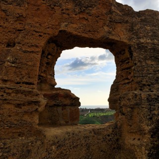 Arkosolium path, necropolis, view through arched niche on coastline and the sea, burial chamber,