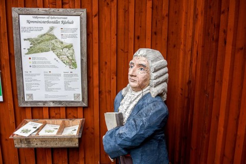 Wooden statue of botanist and founder of the binary nomenclature Carl von Linné with white hair and
