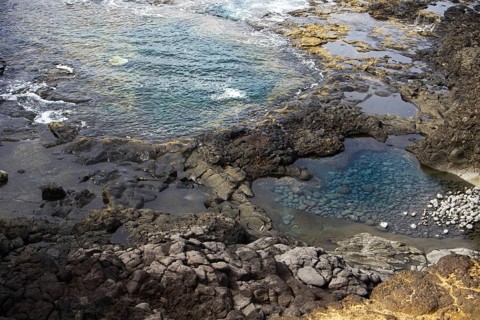 Rocky landscape with cliffs and natural pools with clear water on a rough, wave-driven coast, Yaiza