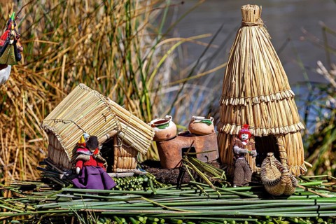 Miniature huts and figures made of straw and clay on a natural support, The floating reed islands