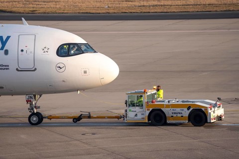Lufthansa City Airbus A320neo is pushed from the gate onto the taxiway, ready to go, to