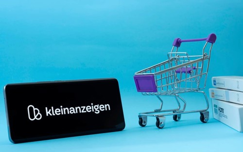 Dhaka, Bangladesh- 03 July 2025: Smartphone with Kleinanzeigen logo next to a small shopping cart