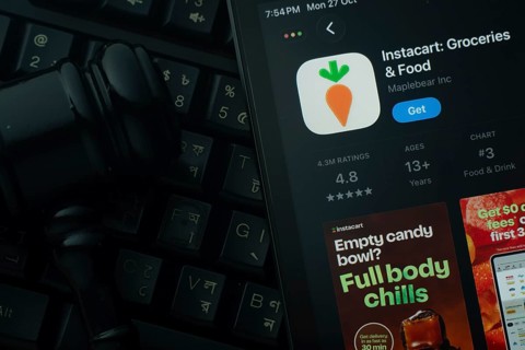 Dhaka, Bangladesh- 28 Oct 2025: An iPad displaying the Instacart app against a judge's gavel and
