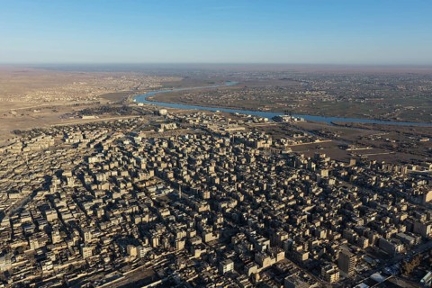 In Deir ez-Zor, Eastern Syria on January 21, 2026, an aerial drone shot captures the city landscape