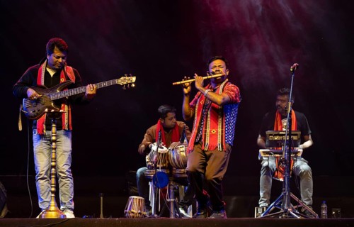 Flutist Dilip Hira performs during a cultural evening program at Shilpgram Mohotsav 2026 in