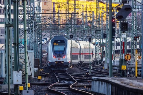 InterCity IC to Zurich leaving Stuttgart Central Station in the morning. Rail signals and overhead