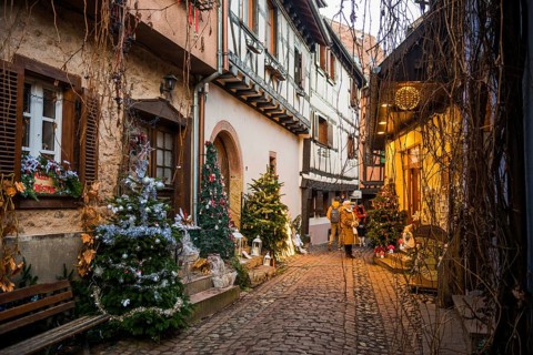 Christmassy decorated houses and alley with half-timbered houses, Christmas market, Eguisheim,