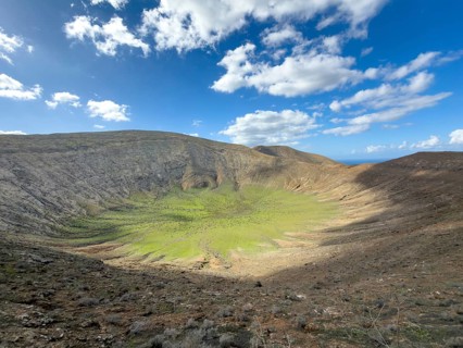 View of the Caldera Blanca volcano cauldron against blue sky with white clouds, Mancha Blanca,