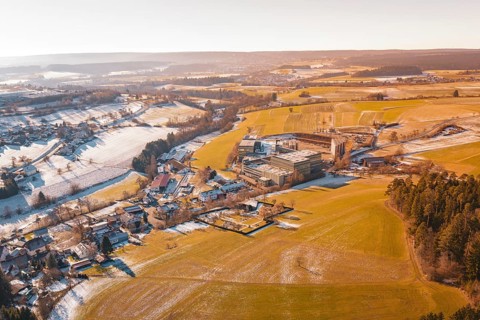 Wide winter field landscape with buildings and horizon at sunrise, Hallwangen, Freudenstadt