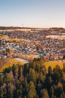 Snow-covered landscape with village and adjacent forest in a wintry atmosphere, Hallwangen,