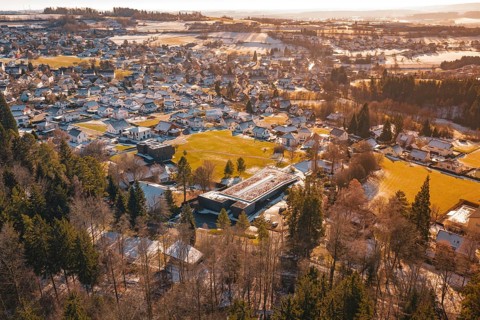 Winter landscape of a small town with snow-covered roofs and surrounding fields, Hallwangen,