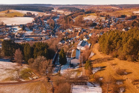 Snowy village nestled in a hilly landscape with forest and fields, Aach, Dornstetten, Freudenstadt