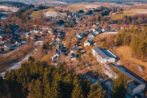 Panoramic view of a snowy village nestled in a hilly forest landscape, Aach, Dornstetten,