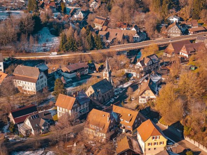 Village in winter with a distinctive church and surrounding snow-covered houses, Aach, Dornstetten,