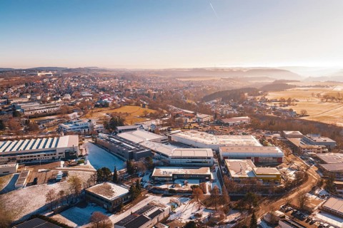 Aerial view of a wintery cityscape with buildings and fields in morning light, Dornstetten,