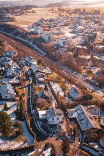 Snowy urban landscape with railway line and scattered houses, Dornstetten, Freudenstadt district,