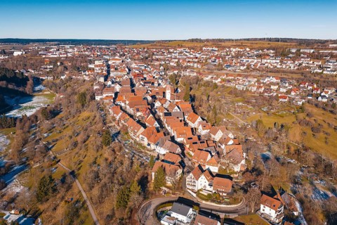 Aerial view of city in winter surroundings with characteristic red roofs, Dornstetten, Freudenstadt