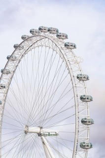 A majestic Ferris wheel dominates the cloudy sky with its capsules, London Eye, London, United