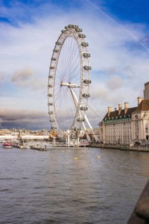 City panorama with a Ferris wheel on a river under clear sky, London Eye, London, United Kingdom
