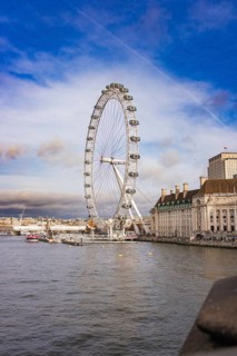 Cityscape with Ferris wheel on riverbank in good weather, London Eye, London, United Kingdom