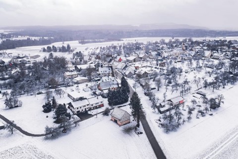Snowy village in a wintry landscape, surrounded by trees and fields, Wiesenstetten, Freudenstadt