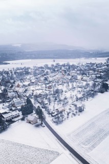 Snowy village surrounded by fields and trees in a wintry landscape, Wiesenstetten, Freudenstadt