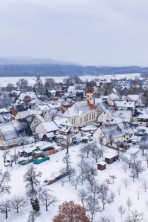 Village in winter with snow-covered houses and a church, cold atmosphere, Wiesenstetten,