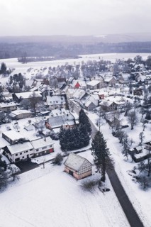 Wintery village with snow-covered houses and trees, cold landscape atmosphere, Wiesenstetten,