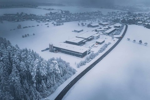 Snowy landscape with forest, surrounding villages and a factory in the foreground, Hörschweiler,