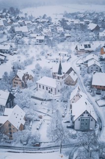 Winter landscape of a village with church and snowy roads, Schopfloch, Freudenstadt district,