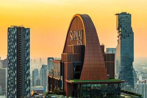 Over the rooftops of Bangkok, sunset, roof structure of the luxury residential residence Supalai