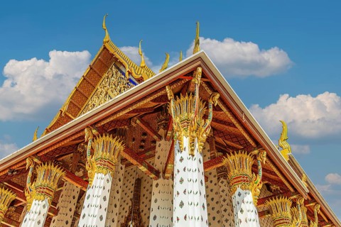 Columns with floral motifs support the gold-colored ceiling of the Wat Arun Buddhist temple,