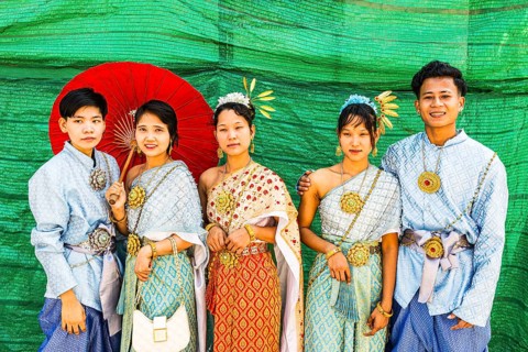 A group of young people wearing traditional clothing presents themselves for the photographers, Wat