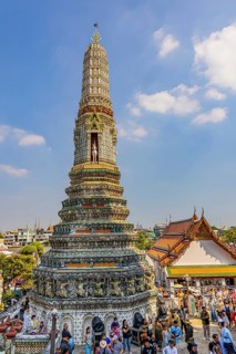 Pagoda with ceramic inlays surrounded by visitors and tourists, Wat Arun Buddhist temple, Bangkok,