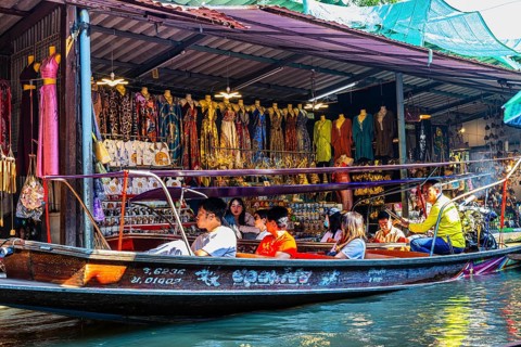 Wooden boat with tourists on the Damneon Saduak floating markets channel, near Bangkok, Ratchaburi