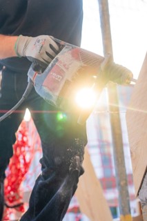 Drills and lighting effects on wood during construction work with construction workers, carpentry