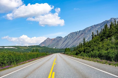 Road through taiga and mountainous landscape, picturesque landscape on Richardson Highway, Alaska,