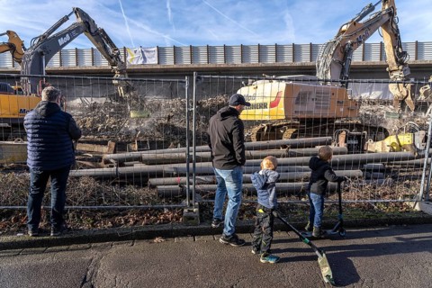 Spectators, teethers during the demolition of the 120 meter long motorway bridge of the A516,